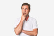 © Asier - A middle-aged man isolated looking sideways with doubtful and skeptical expression.