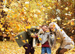 © KOTO - Three generations of women playing in autumn leaves
