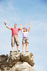 Canvas Print - Climbers cheering on rocky hilltop