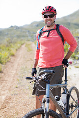 Wall Mural - Mountain biker smiling on dirt path