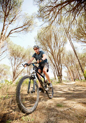 Canvas Print - mountain biker on dirt path