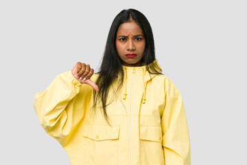 Wall Mural - Young Indian woman cut out isolated on white background showing a dislike gesture, thumbs down. Disagreement concept.