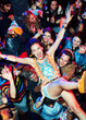 © KOTO - Enthusiastic woman crowd surfing at music festival