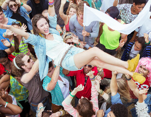 Wall Mural - Woman crowd surfing at music festival