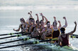 © KOTO - Rowing team celebrating in scull on lake