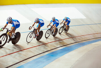 track cycling team riding in velodrome