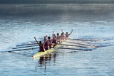Fototapeta Miasto - Rowing team celebrating in scull on lake