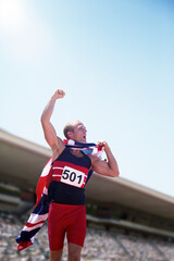 Wall Mural - Track and field athlete cheering with British flag