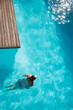 © KOTO - Woman in swimming pool