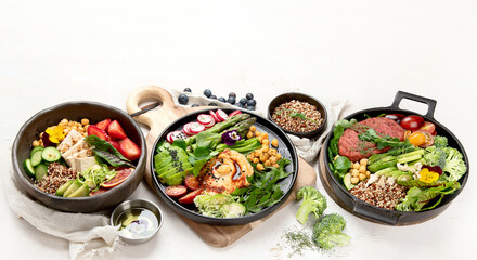Wall Mural - Healthy vegetarian and vegan  salads and Buddha Bowls with vitamins, antioxidants, protein on light  background.