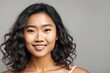 © Pictures Paradise - Portrait of a beautiful young asian model looking at camera. With curly hair and clean healthy facial skin. Skin care. Copy space.