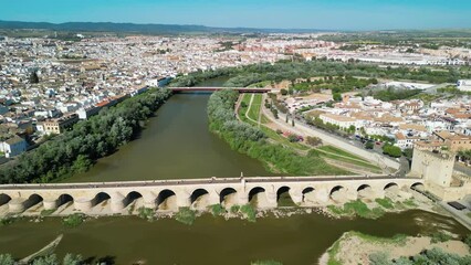 Sticker - Cordoba, Andalusia. Aerial view of city medieval buildings and bridge on a sunny spring day