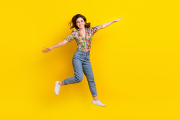 Sticker - Full size photo of jumping fly hands wings girl wearing trendy flowers print summer blouse lightweight isolated on yellow color background