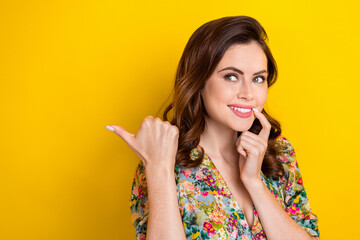 Poster - Photo of sweet dreamy lady wear retro flower print blouse pointing thumb looking empty space isolated yellow color background