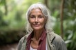 © Markus Schröder - Medium shot portrait photography of a tender mature woman wearing a chic cardigan against a scenic tropical rainforest background. With generative AI technology