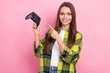© deagreez - Portrait of cheerful pretty girl indicate finger hand hold controller isolated on pink color background