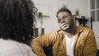 © Synthex - African American man talking to his girlfriend, couple communicating at home, relationship