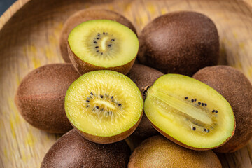 Wall Mural - organic kiwi fruit with cut in half and leaves, Food background. Close up