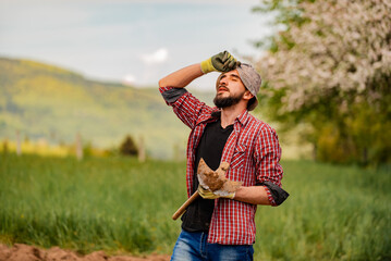 Sticker - Male farmer looking tired after day of work on an agricultural fields.