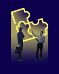 Wall Mural - two young men, employees, colleagues working on project. neon colored puzzle icon symbolizing teamwo