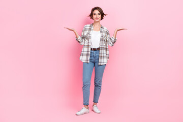 Full length photo of pretty sweet lady wear checkered jacket comparing arms empty space isolated pink color background