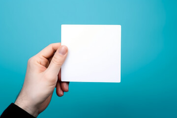 Poster - empty white blank mockup in hand on blue background generative ai