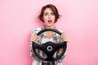 © deagreez - Photo of impressed confused girl hands hold wheel open mouth staring isolated on pink color background