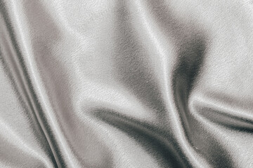 Golden shiny texture of silk satin satin with folds.