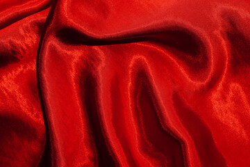 Wall Mural - Red shiny texture of silk satin satin with folds.