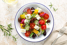Greek Salad. Vegetable Salad With Feta Cheese, Tomato, Olives, Cucumber, Red Onion And Olive Oil. Healthy Vegetarian Mediterranean Diet Food. Top View