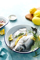 Canvas Print - Fresh raw dorado fish cooking with lemon and rosemary. Sea bream, dorado. Seafood, healthy food