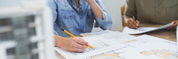 Architects interior designer hands working with Blue prints and documents for a home renovation for house design