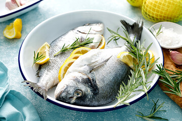 Canvas Print - Fresh raw dorado fish cooking with lemon and rosemary. Sea bream, dorado. Seafood, healthy food