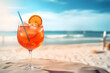 Aperol spritz on a white sandy beach with a sea view and space for text