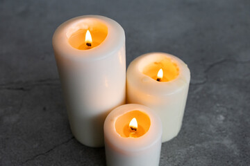 Wall Mural - White candles on a gray background