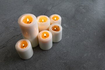 Wall Mural - White candles on a gray background