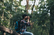 © Charnchai saeheng - Hikers  with backpacks use camera shooting lanscape in the forest. hiking and adventure concept.