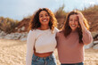 © bernardbodo - Portrait of two diverse young girl friends on beach.