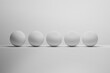 A row of five identical white spheres or balls - 3D RENDER