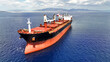 Aerial drone photo of huge industrial bulk carrier tanker anchored in deep blue Aegean sea