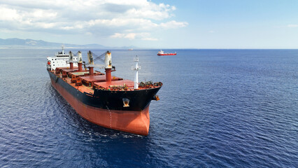 Aerial drone photo of huge bulk carrier tanker anchored in deep blue Aegean sea