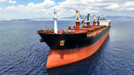 Aerial drone photo of huge bulk carrier tanker anchored in deep blue Aegean sea