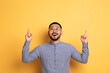 © Prostock-studio - Place For Ad. Excited young asian man pointing up at copy space