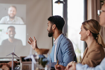 Wall Mural - Young colleagues having meeting, consulting about green energy.