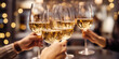 © Jasmina - Close up of group of friends toasting with glasses of white wine at restaurant