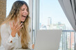 © SETO fotografias - young latin woman at home working very angry because her laptop is broken