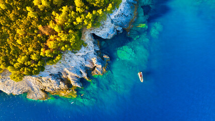 Wall Mural - A sea bay. Clear turquoise water and a boat. View from the air. Summer landscape from a drone. Rest and travel in the summer time. The season for vacation. Photography for design.