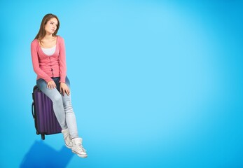 Canvas Print - Nice young female traveler with a suitcase