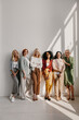 © gstockstudio - Group of beautiful mature women bonding and smiling while leaning on the wall together