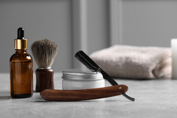 Set of men's shaving tools on grey table